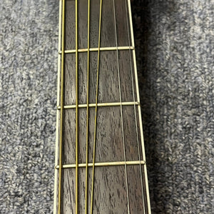 Close-up of the fretboard with four metal strings and visible frets, set against textured gray fabric—this is a vintage Sigma DR-35 acoustic guitar (Made in Japan), inspired by the Martin D-35, sold with case.