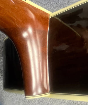 Close-up of the neck joint on a Japanese-made Sigma DR-35, highlighting its polished wood grain and cream binding—details inspired by the Martin D-35. Includes original case.
