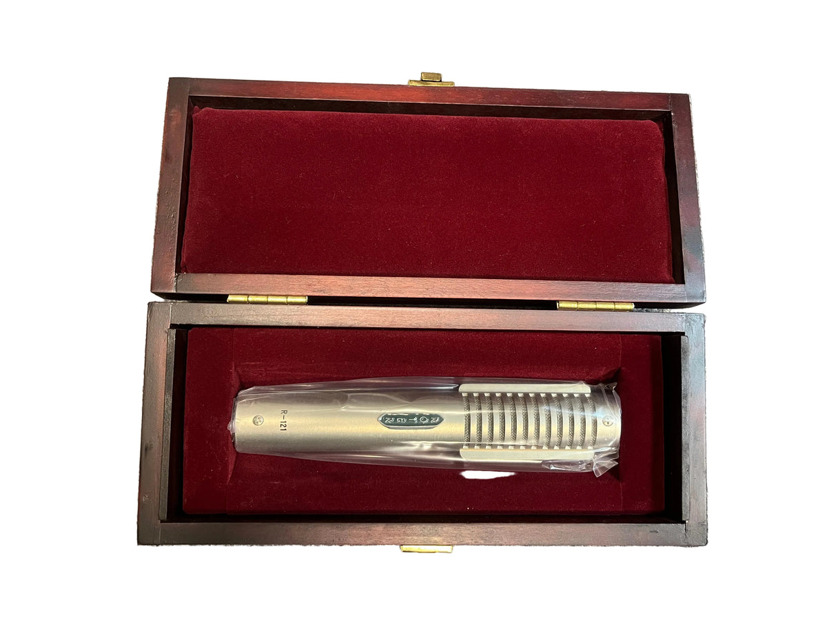 A pre-owned Royer Labs R-121 Ribbon Microphone in excellent condition sits in a red velvet-lined wooden box with an open lid, perfect for your next studio recording session.