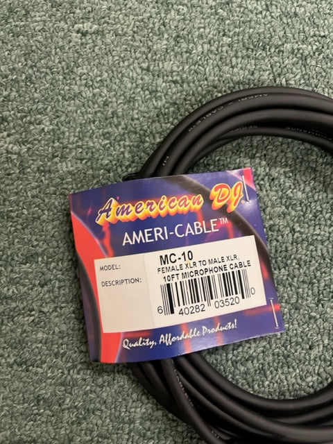 A coiled black American DJ MC-10 10ft XLR Microphone Cable lies on a textured green surface, with a label indicating "Female XLR to Male XLR.