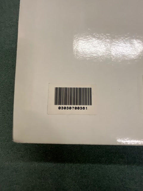 A close-up of a barcode sticker on a white surface, displaying the number 03030700361 below the barcode—identifying a Monster Power PRO 7000 Professional Reference PowerSource by Monster Power.