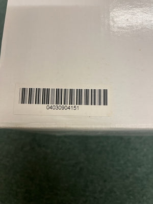 A white box with a barcode sticker showing 04030904151, possibly containing a Monster Power AVS 2000 PRO Professional Reference Automatic Voltage Stabilizer by Monster Power, rests on a green surface.