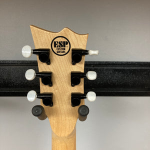The back of an ESP Standard Eclipse Transparent Cherry Red guitar headstock shows six tuning pegs and the Esp Custom Guitars logo on a light wood finish.