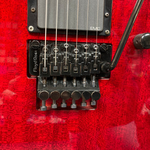 Close-up of an ESP Standard Eclipse electric guitar in Transparent Cherry Red, made in Japan, featuring a Floyd Rose locking tremolo bridge, EMG pickup, and includes case.
