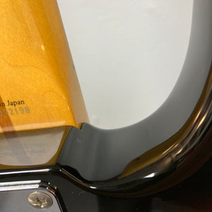 Close-up of a Fender Sting P Bass Sunburst neck joint by Fender, showcasing detailed wood grain, part of the serial number, and glossy finish—a great detail for fans of vintage-style electric bass guitars.