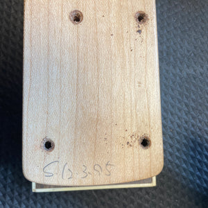 A close-up of the ESP Standard Eclipse Transparent Cherry Red guitar body by Esp, showing four drilled holes and "CL 395" handwritten at the bottom, set against a textured dark background.