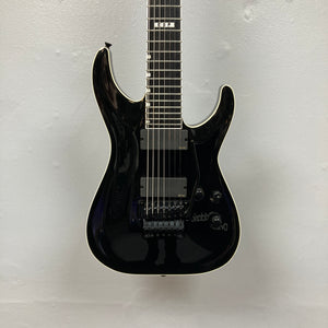 An ESP E-II Horizon FR-7 Black 7-string electric guitar by ESP with a glossy finish, Floyd Rose bridge, two pickups, white body binding, and whammy bar is pictured against a plain white background.