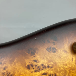 Close-up of the Ibanez SDGR SR500PB bass by Ibanez, featuring a glossy brownish-yellow sunburst finish, textured wood grain, smooth flatwound strings, and includes a hard case.