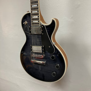 A used Schecter Solo-II Custom Trans Black Burst w/Case by Schecter hangs on a white wall, featuring chrome hardware, cream binding, black pickguard, and Pasadena USA pickups.