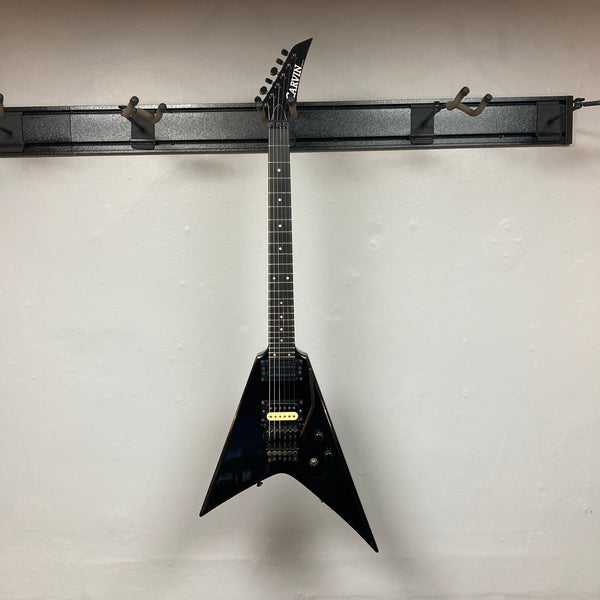 Black 1992 Carvin Ultra V USA guitar with Kahler Steeler tremolo, MJ-wound Seymour Duncan DCJ humbuckers, and control knobs, photographed against a plain light-colored wall.