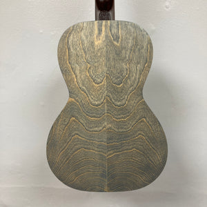 The back of the Art & Lutherie Roadhouse Denim Blue Q-Discrete Parlor Acoustic Guitar displays a wood grain pattern with wavy, symmetrical lines on a light-colored background.