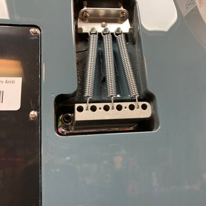 Close-up of the back of a Godin Session T-Pro Arctik Blue MN SF with Bag, highlighting the tremolo spring cavity, three springs, and part of the bridge. Features HSS Seymour Duncan pickups from Godin.