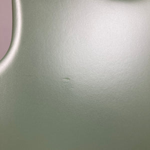 Close-up of the Godin Radium Matte Green RN SF w/GigBag’s smooth, matte surface by Godin, highlighting a small central indentation and subtle H-S-H tonal details.