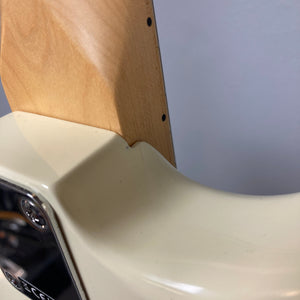 Close-up of the neck joint on a Fender Standard Stratocaster Olympic White Refurb by Fender, highlighting the connection between the neck and body just above its single coil pickups.