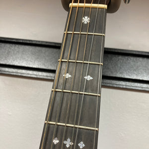 Close-up of the Guild Gad-30reasb w/Case guitar neck, featuring strings, frets, and decorative inlays on a solid Indian rosewood fingerboard, set against a white wall background.