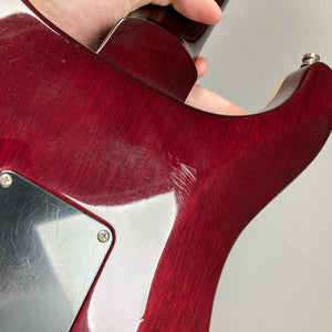Close-up of the back of a PRS Custom 24 Violet 2011 electric guitar by PRS, showing visible scratches and wear near the neck joint and plastic backplate.