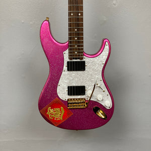 An Edwards ESP E-SN-185-TO Takayoshi Ohmura electric guitar in Twinkle Pink, featuring dual humbuckers, a white pickguard, gold hardware, and a red sticker with Chinese characters and a gold dragon on the lower body, displayed against a plain gray background.