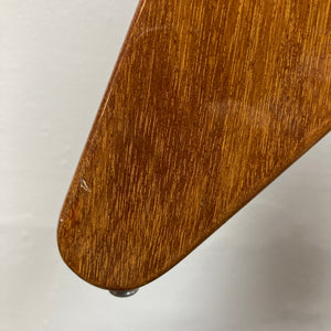 Close-up of a wooden furniture leg featuring a natural finish and glossy sheen, highlighting minor scratches and detailed wood grain reminiscent of the character found in a vintage 1975 Gibson Flying V w/Case by Gibson, set against a plain background.