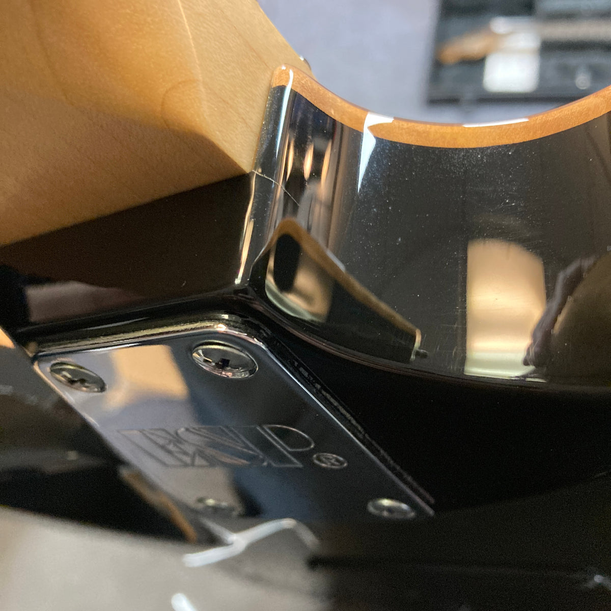 Close-up of the neck joint on the 2019 ESP USA M-II in Purple Haze Burst, highlighting its glossy finish, metal neck plate with screws, and a section of the wooden neck.