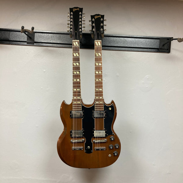 A 1978 Gibson EDS-1275 Double Neck Walnut electric guitar by Gibson, featuring a brown walnut finish, black pickguards, and multiple control knobs, photographed against a plain white background.