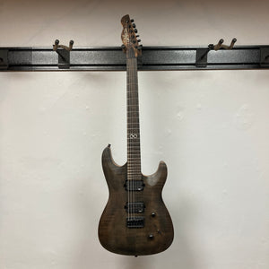 A Chapman ML1 Pro Modern Lunar electric guitar by Chapman, featuring a dark finish, 24 frets, and dual humbucker pickups, hangs on a wall-mounted guitar rack against a white background.