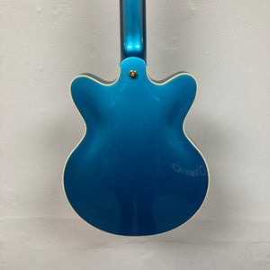 Back view of a Gretsch G2655TG Streamliner Riviera Blue Refurb semi-hollow electric guitar with cream-colored binding, set against a plain white wall.