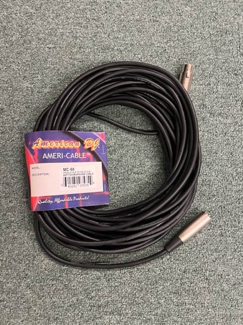 A coiled American DJ MC-50 50ft XLR Microphone Cable with its packaging label attached is displayed on a carpeted floor.