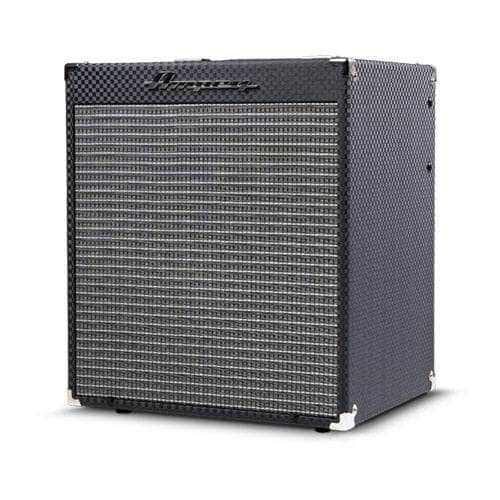 The Ampeg RB110 Rocket Bass Amp features a black textured cabinet, silver grille cloth, white corner protectors, and the Ampeg logo on the top left. Shown on a white background, it includes Super Grit Technology for classic Ampeg tone.