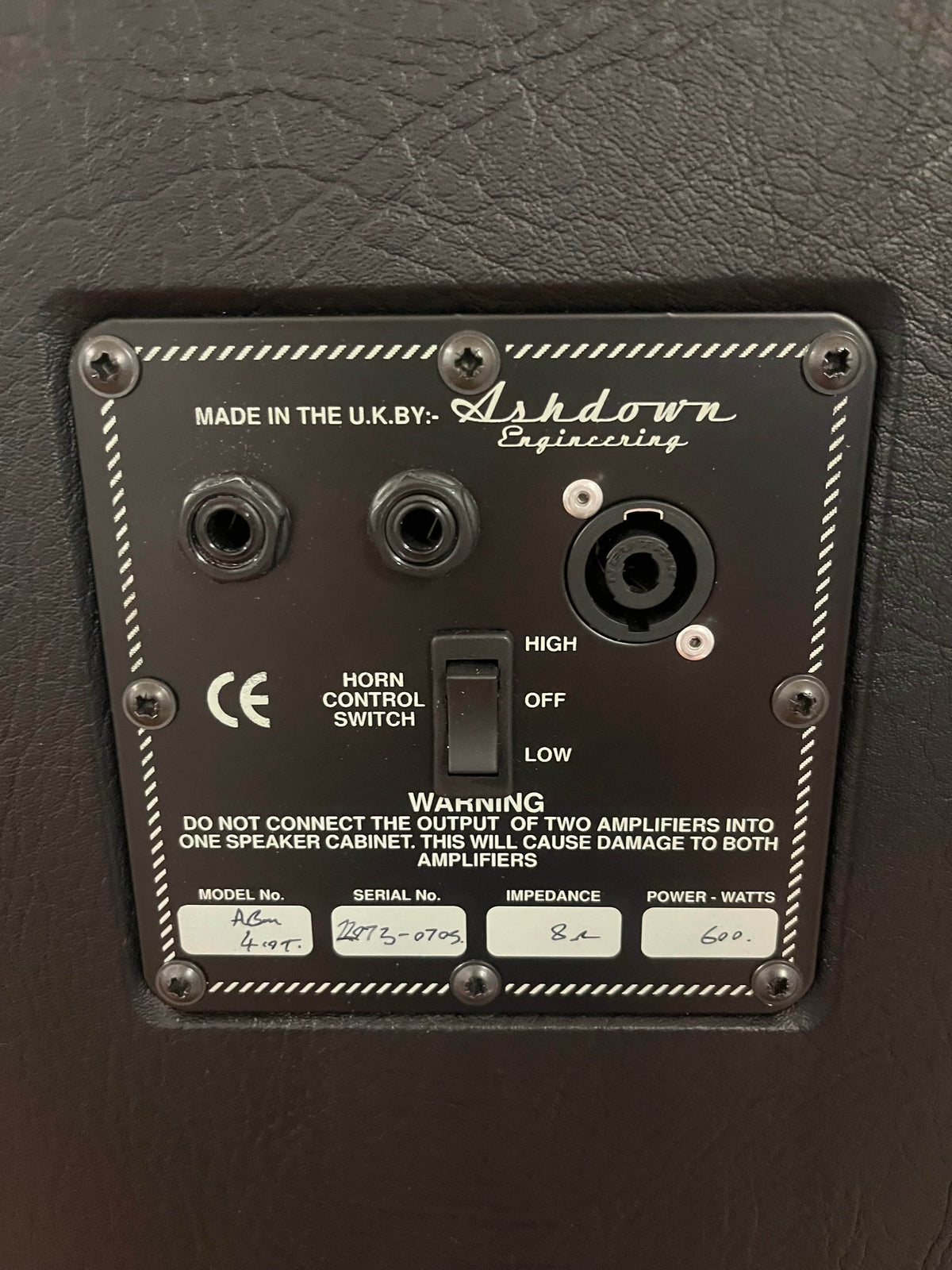 A close-up of an Ashdown UK Built ABM Bass Rig Full Stack speaker panel, featuring jacks, horn control, model and serial numbers, impedance, and power ratings from the EVO II 900 Head with 410T and 115-500 cabinets in flight cases.