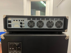 The rear panel of the Ashdown UK Built ABM Bass Rig Full Stack, featuring the EVO II 900 Head, displays cooling fans, I/O ports, switches, and a power socket on an Ashdown 410T and 115-500 bass cabinet.