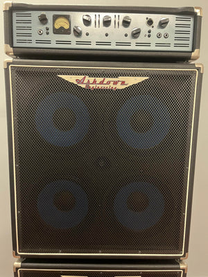An Ashdown UK Built ABM Bass Rig Full Stack, featuring the EVO II 900 Head with control knobs and meter, sits atop matching 410T and 115-500 cabinets, all by Ashdown.