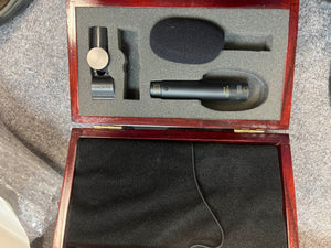 A foam-lined wooden case with a black cloth bottom includes a preowned Audix SCX1-hc Professional Hypercardioid Condenser Microphone, foam windscreen, and mic clip.