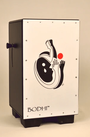 The Bodhi Cajon Drum - Art Collection #2 by Bodhi is a black and white rectangular drum featuring two abstract figures, a red circle on the front panel, and "BODHI" printed at the bottom left—an ideal addition to any art collection.