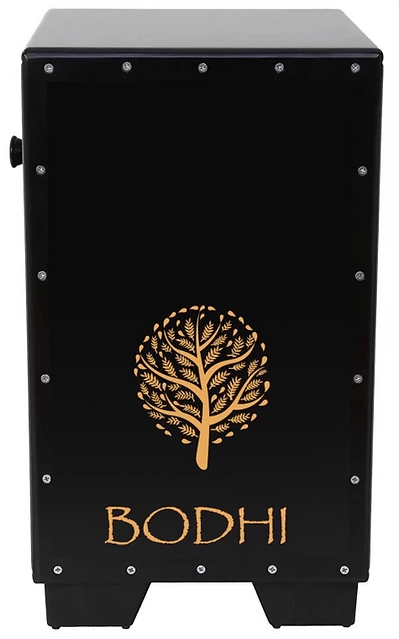 The Bodhi Cajon Drum - Satin Black by Bodhi is a rectangular percussion instrument featuring metal rivets, a gold tree design, and "BODHI" in gold, combining striking visual appeal with versatile performance.