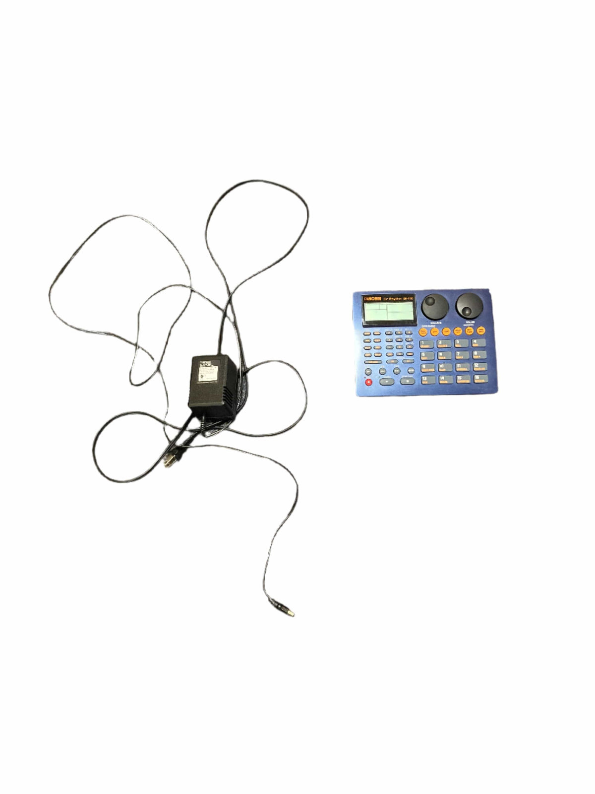 Boss Dr. Rhythm DR-770 drum machine with display and buttons, accompanied by a power supply cord.