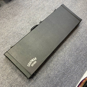 A Chapman ML1 Pro Modern Lunar electric guitar case by Chapman, designed for a dual humbucker, 24-fret model, lies closed on a gray carpeted floor and is photographed from above.