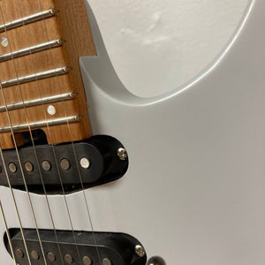 Close-up of a Used Charvel DK24 HSS 2PT CM Electric Guitar - Gray, showing the neck with metal frets and strings, a wooden fretboard, body cutaway, and visible Seymour Duncan pickups. Brand: Charvel.