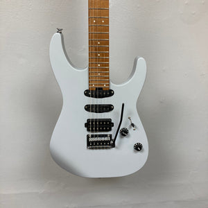 A used Charvel DK24 HSS 2PT CM Electric Guitar in gray, featuring Seymour Duncan pickups, a whammy bar, two knobs, and a five-way switch, is shown against a plain light-colored wall.
