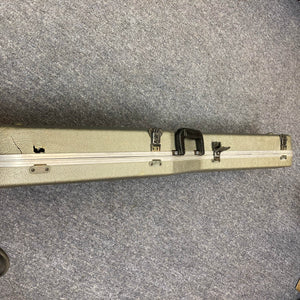 A Charvel Model 4 HSS Red with original hard case showing visible damage and a crack on the left side, resting on a gray carpet—ideal for safely storing your vintage Charvel guitar.