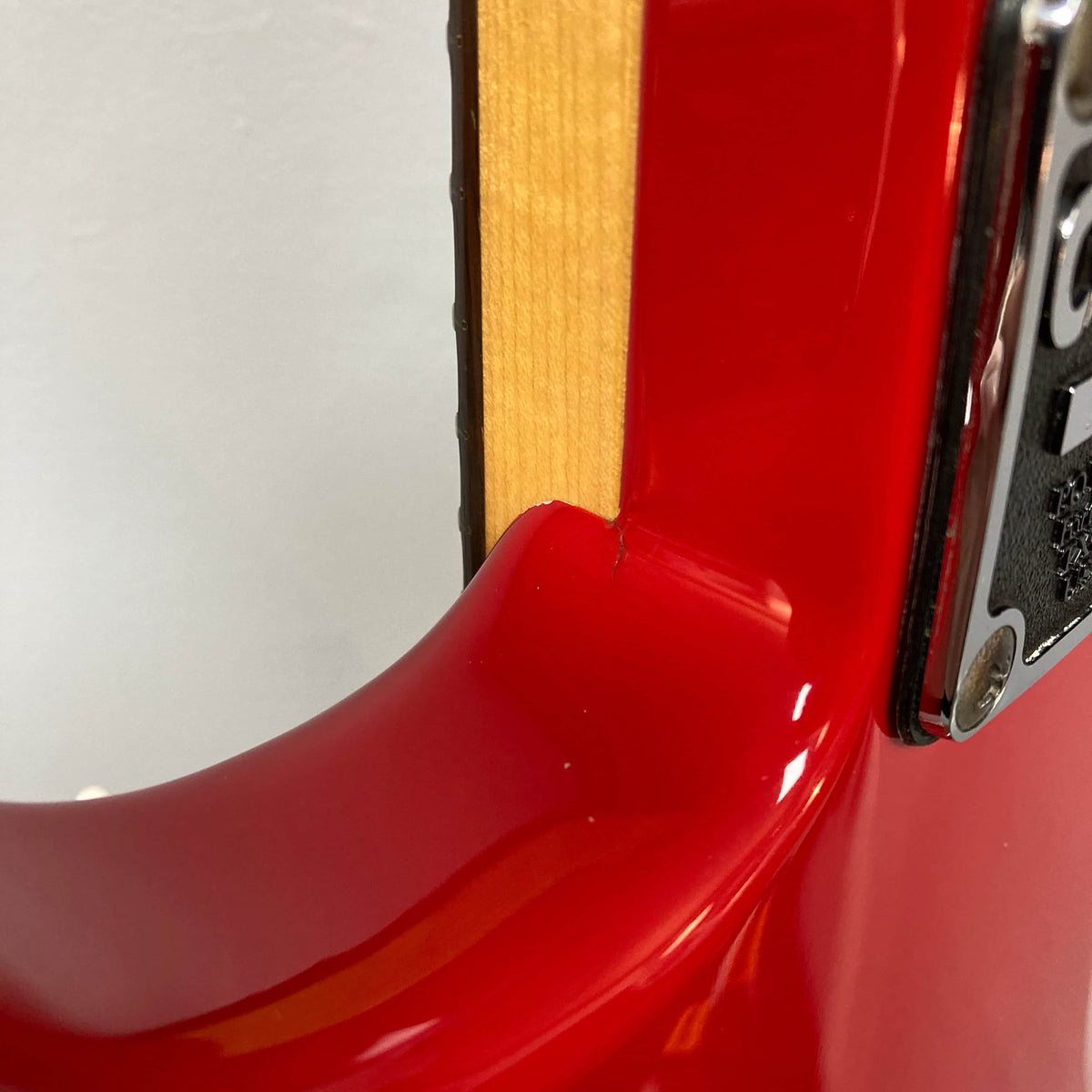Close-up of a Charvel Model 4 HSS Red electric guitar body, highlighting the neck joint and metal plate with screws, displaying classic HSS features—Brand: Charvel.