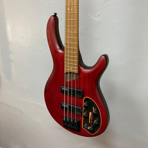Cort Artisan B4 Element Burgundy Red bass guitar displayed on a wall, showcasing its ergonomic design and high-quality components.