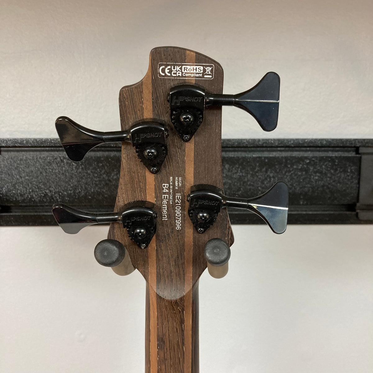 Cort Artisan B4 Element Natural bass guitar close-up, showcasing its roasted maple fretboard, Bartolini pickups, and MetalCraft M4 bridge with dual string-loading.