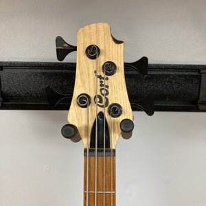 Cort Artisan B4 Element Natural bass guitar headstock with tuning pegs, showcasing premium craftsmanship and advanced features like Hipshot® Ultralite tuners.