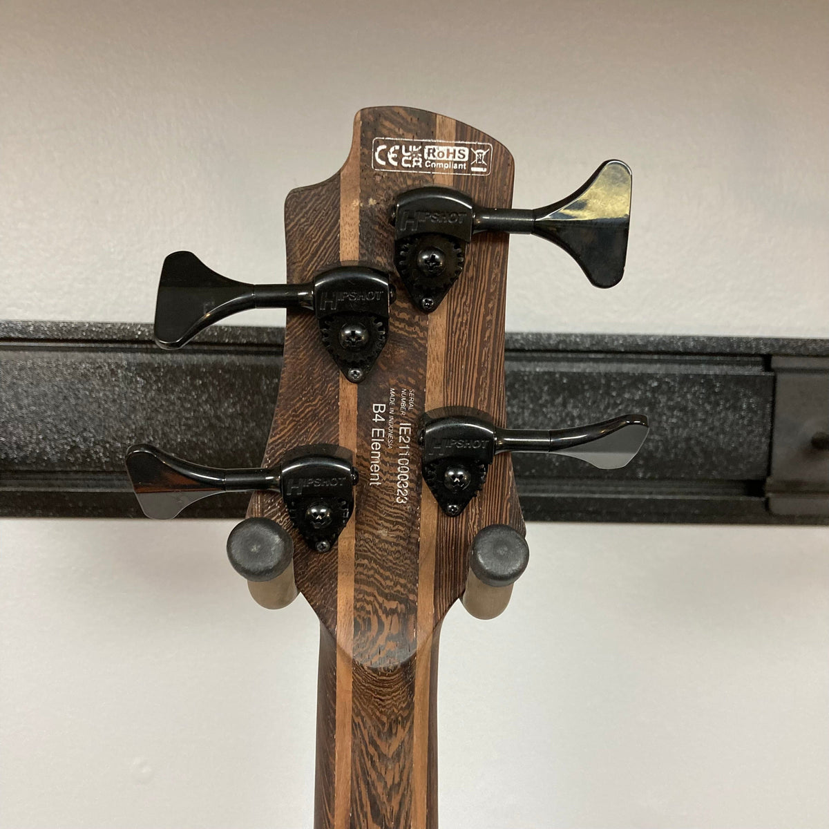 Close-up of the Cort Artisan B4 Element Open Pore Black bass guitar, showcasing its detailed craftsmanship and high-quality components.