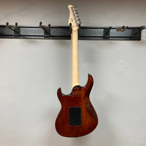 Cort G280 Select Amber electric guitar on a wall hook, showcasing its Pearloid pickguard, Rosewood fingerboard, and high-grade Voiced Tone VTH-77 humbucker.