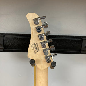 Close-up of the Cort G280 Select Amber guitar, highlighting its Pearloid pickguard, Rosewood fingerboard, and Voiced Tone VTH-77 hot humbucker with metal cover.