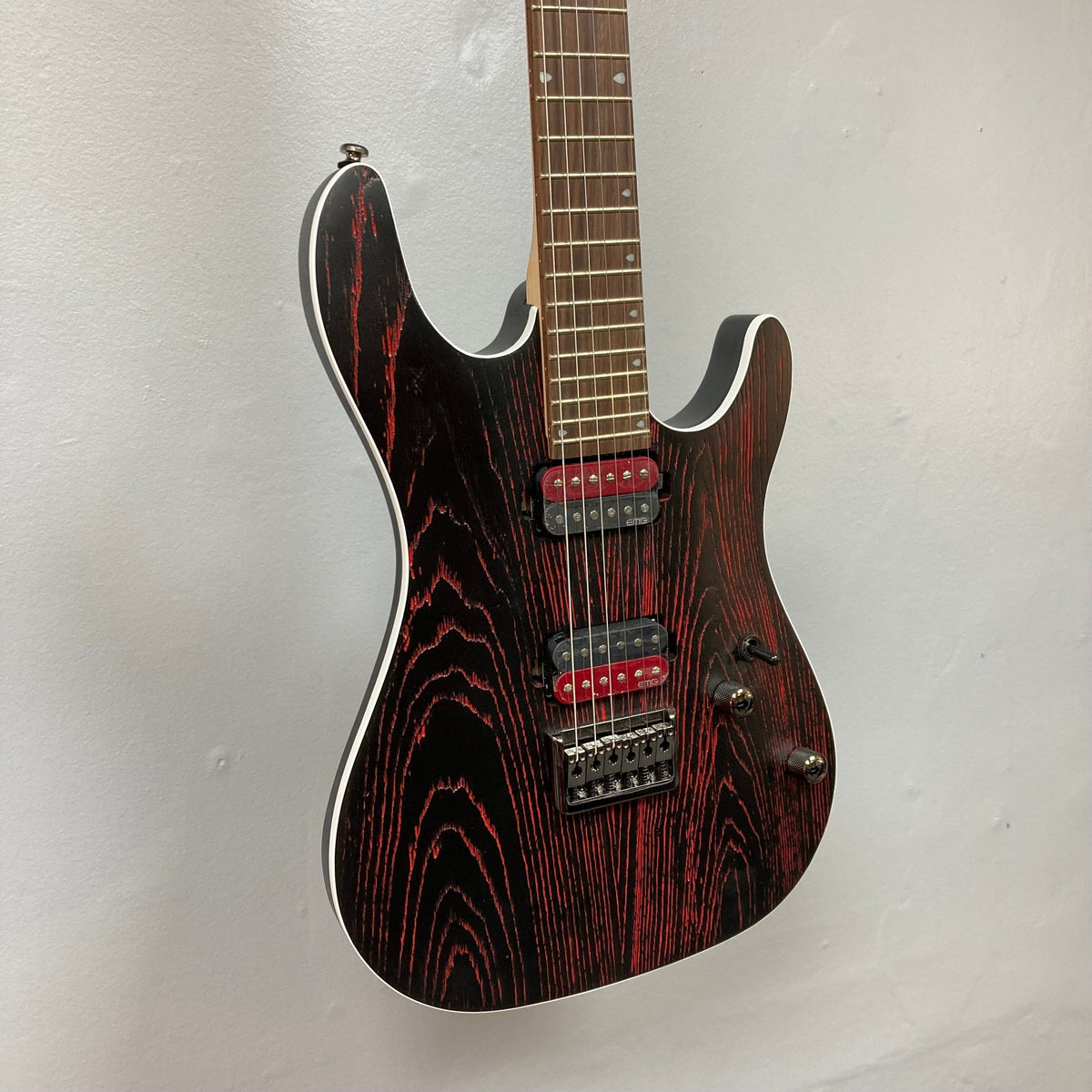 Cort KX300 EBR Etched Black Red electric guitar with red accents and EMG® RetroActive Super77 humbuckers, showcasing a sandblasted ash top and mahogany body.