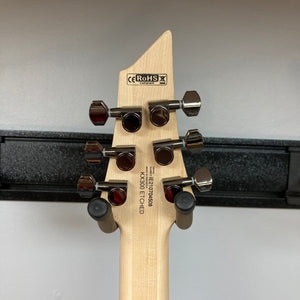 Close-up of a Cort KX300 EBR Etched Black Red guitar, highlighting its ash top with matte black finish and EMG® RetroActive Super77 humbuckers.
