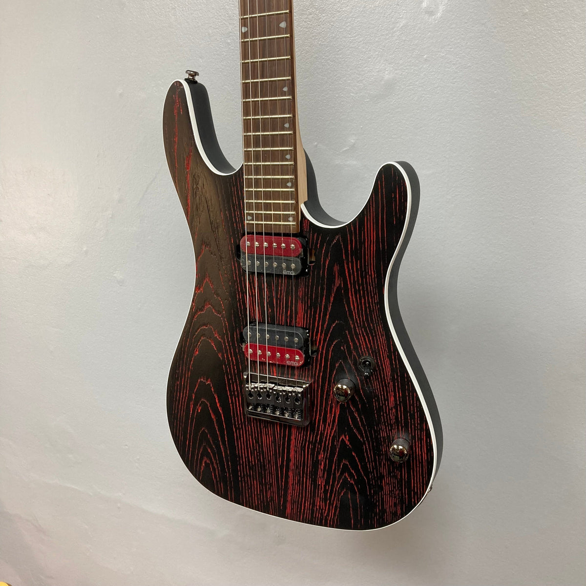 Cort KX300 EBR Etched Black Red electric guitar with matte black finish and red accents, featuring EMG® RetroActive Super77 humbuckers and a hardtail bridge.