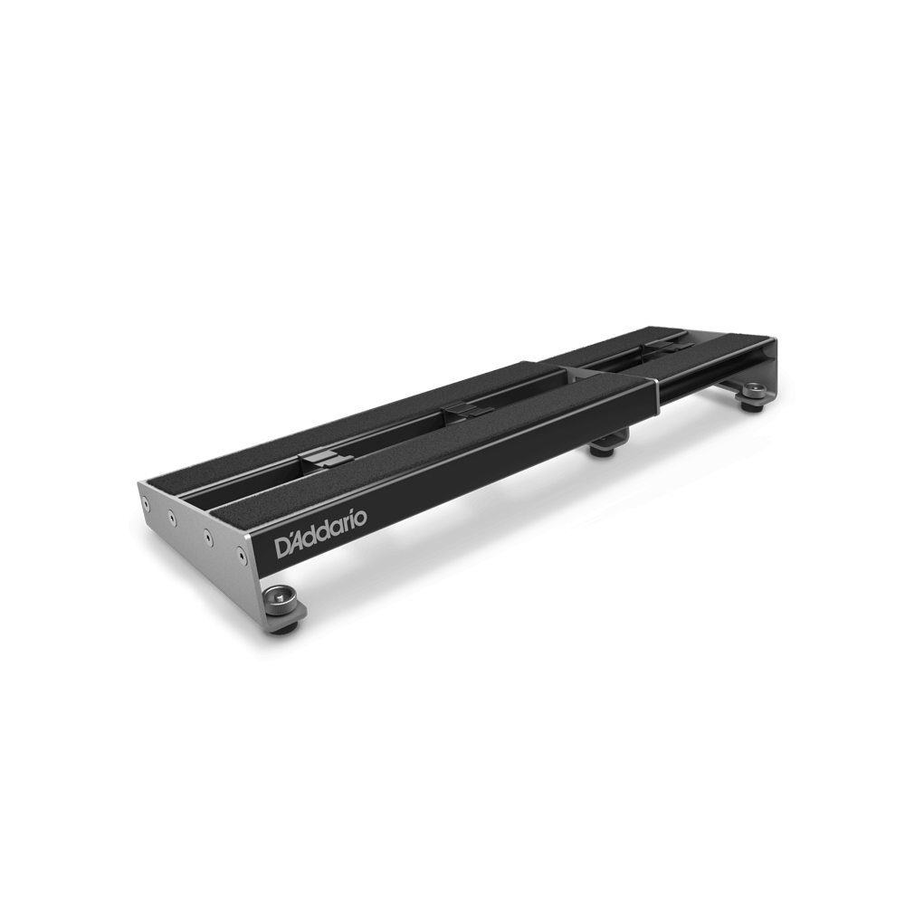 A D'Addario XPND Expanding Pedalboard by D'Addario, featuring a sleek black rectangular metal frame and four rubber feet, is displayed at an angle on a plain white background.